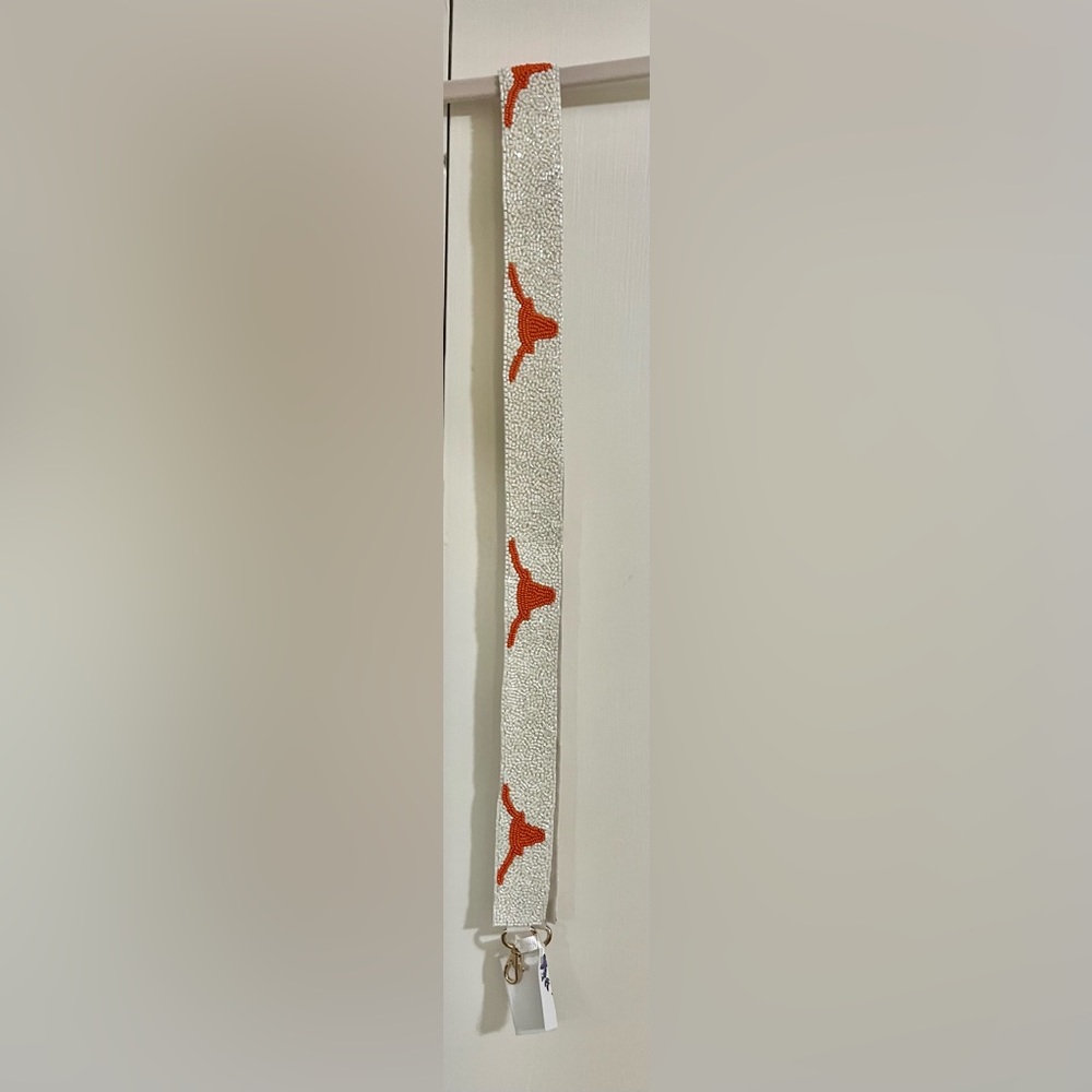 University of Texas Longhorns purse strap. New with tags. Approximately 48”